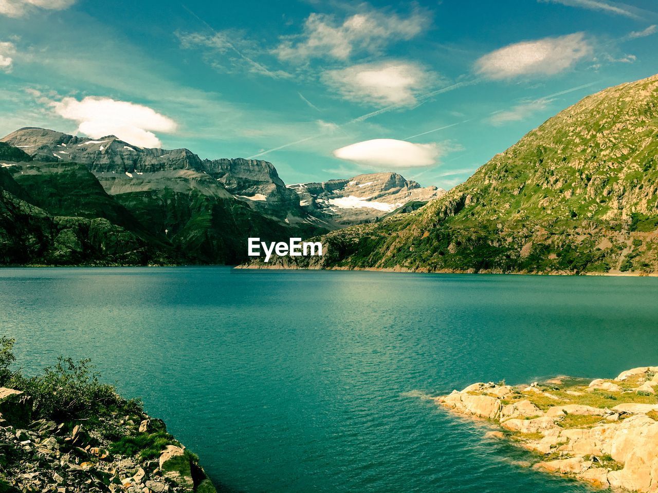 Scenic view of lake and mountains against sky