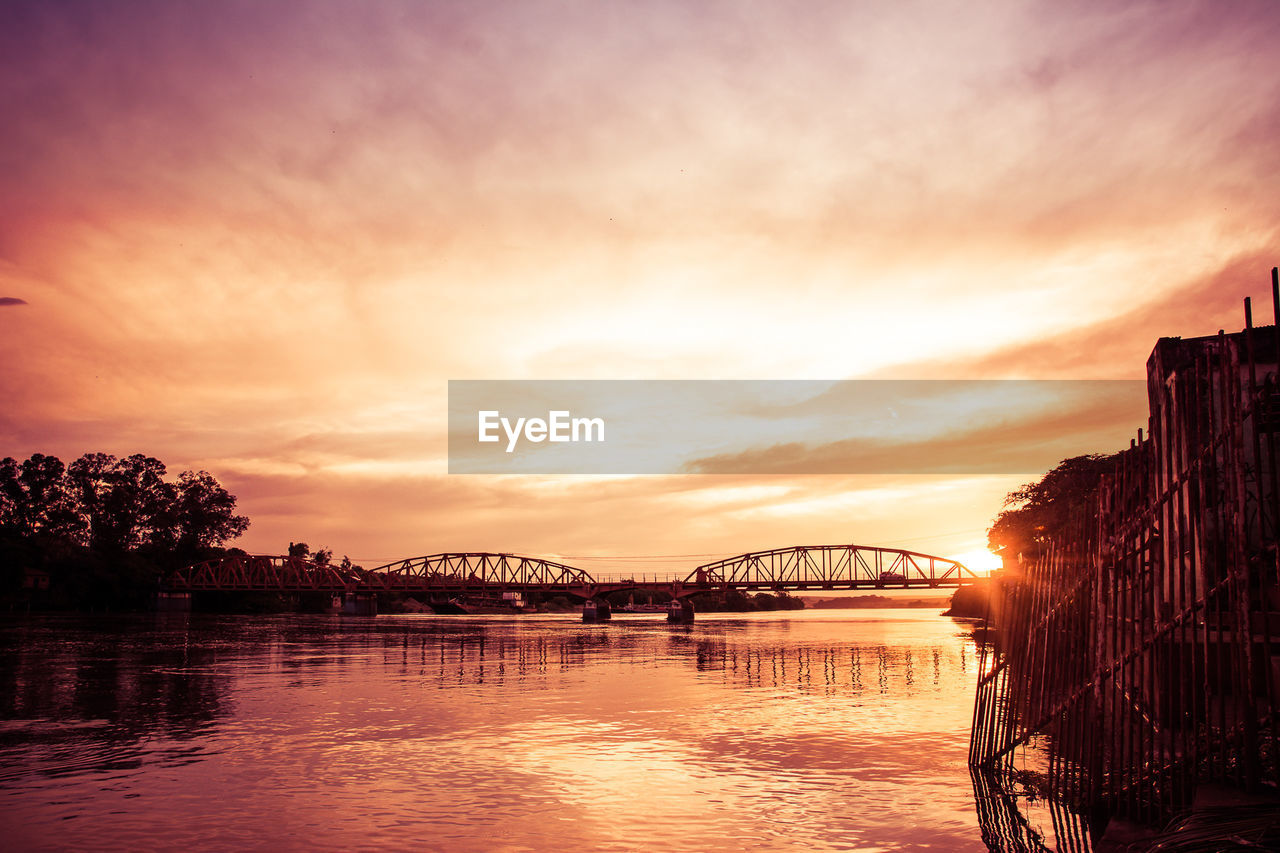 View of bridge over river during sunset