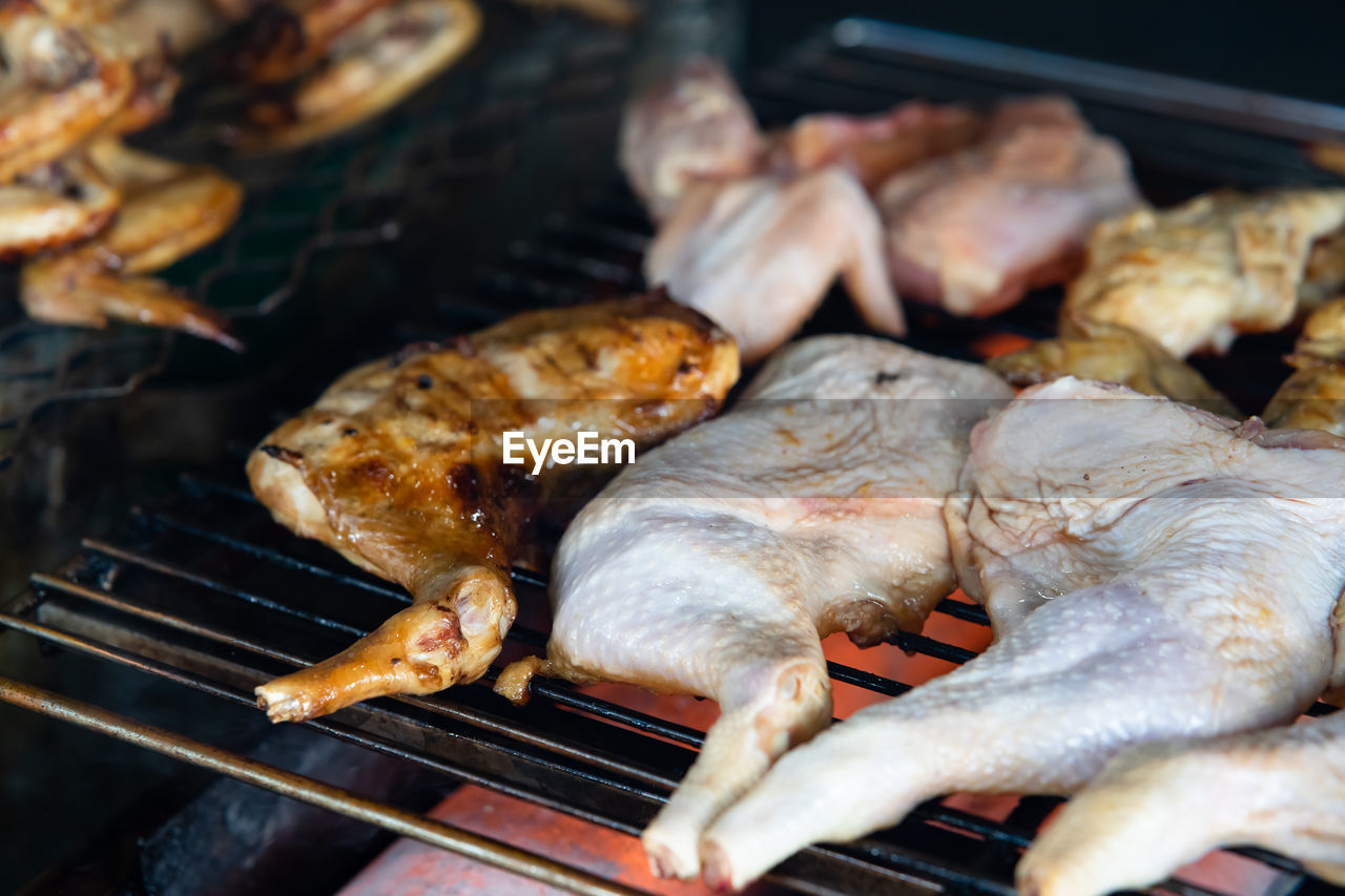 Ayam bakar or charcoal-grilled chicken. roasted chicken in the smoky burning process.