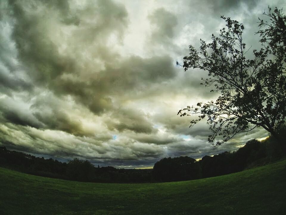 Wide angle shot of landscape against cloudy sky