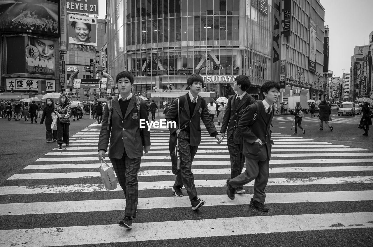 PEOPLE CROSSING ROAD