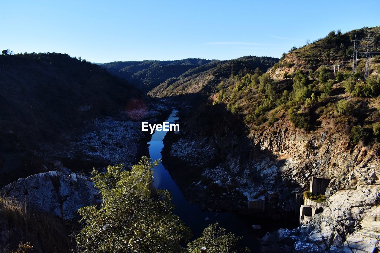 SCENIC VIEW OF ROCKS AGAINST SKY