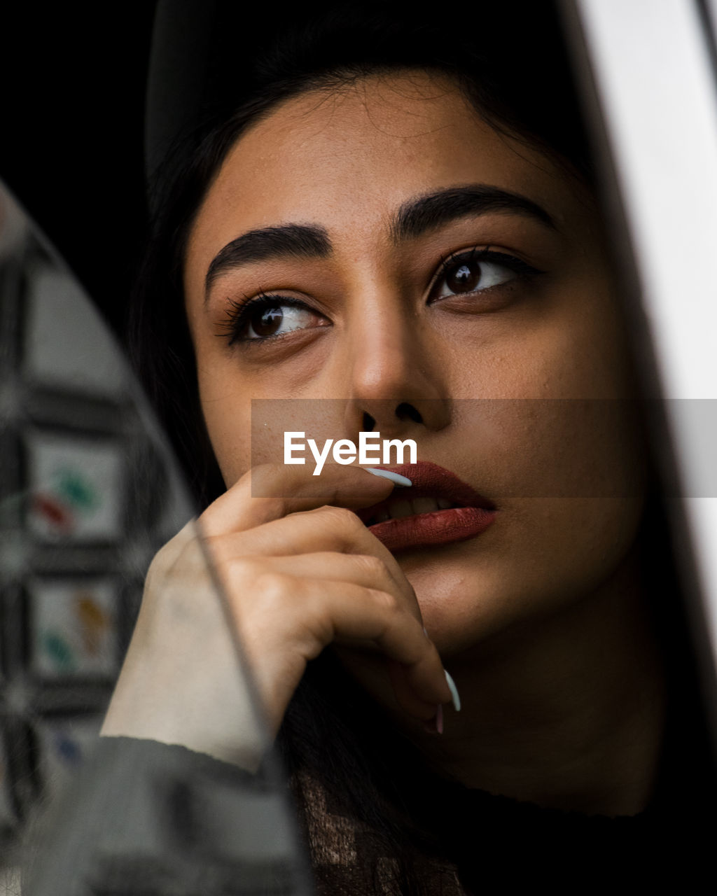 Close-up portrait of young woman looking away