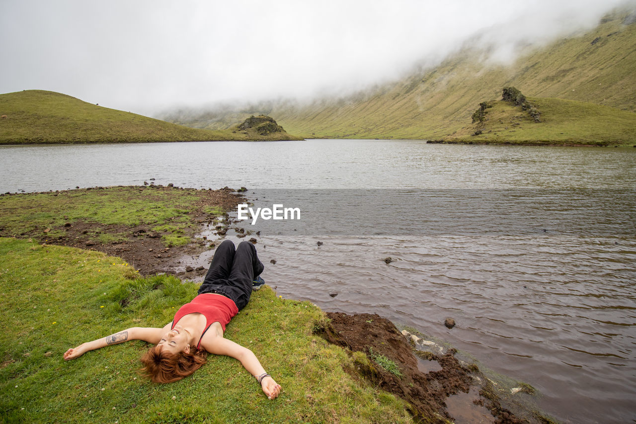 Woman enjoying nature, corvo island, azores, by the lake, wanderlust.