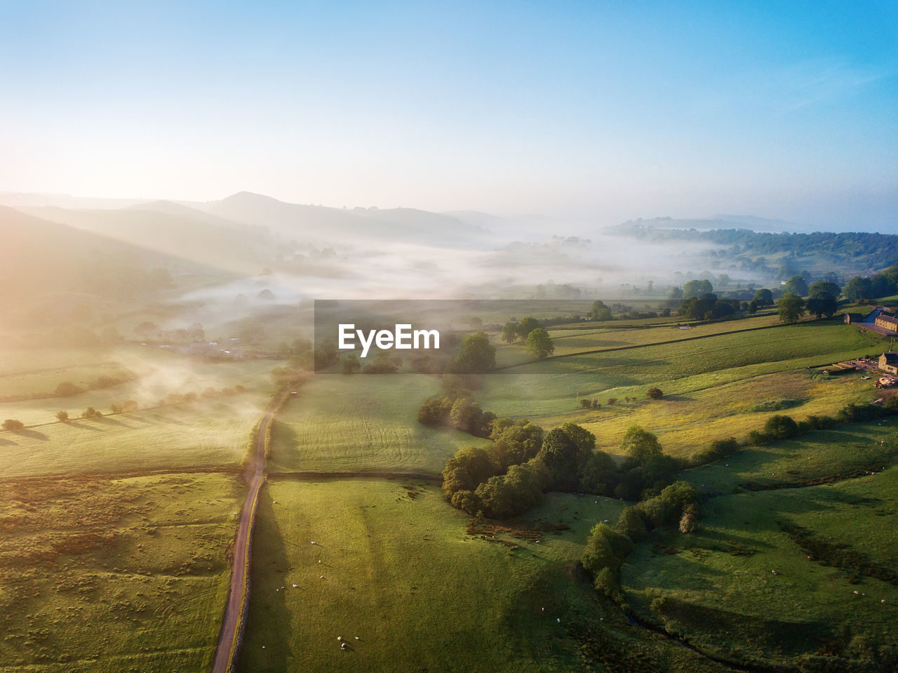 Scenic view of agricultural landscape against sky