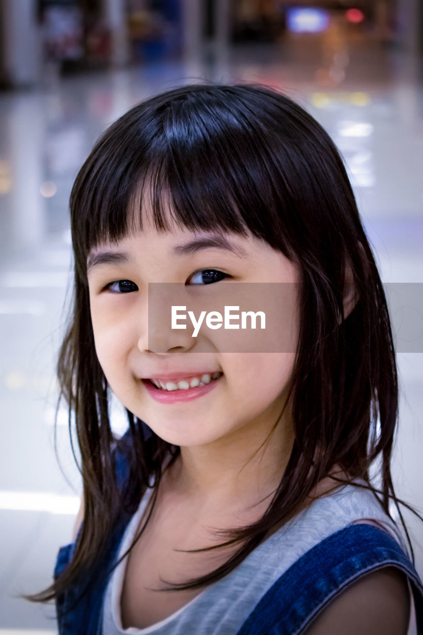 Portrait of girl standing at shopping mall