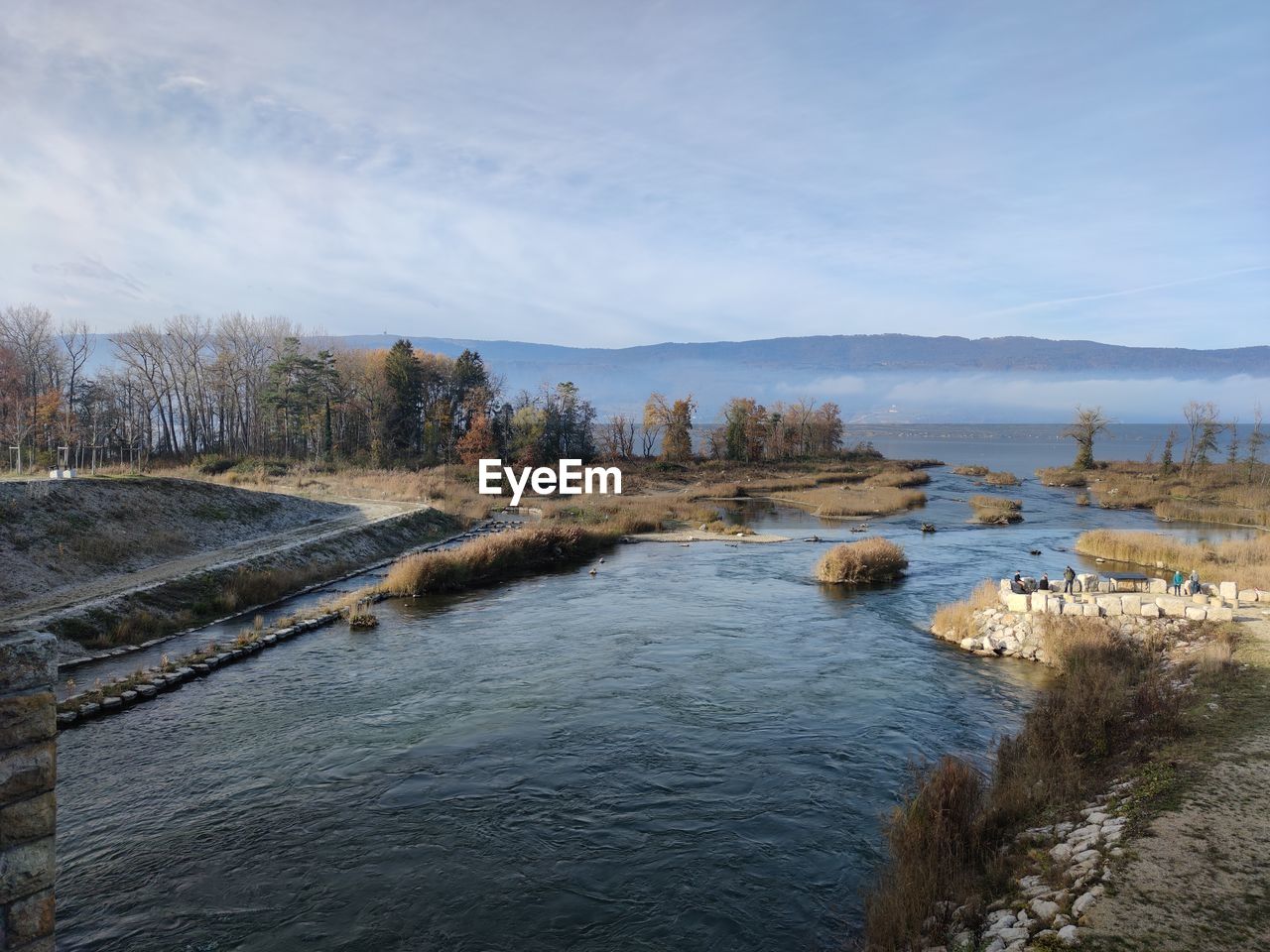 SCENIC VIEW OF RIVER AMIDST ROCKS AGAINST SKY