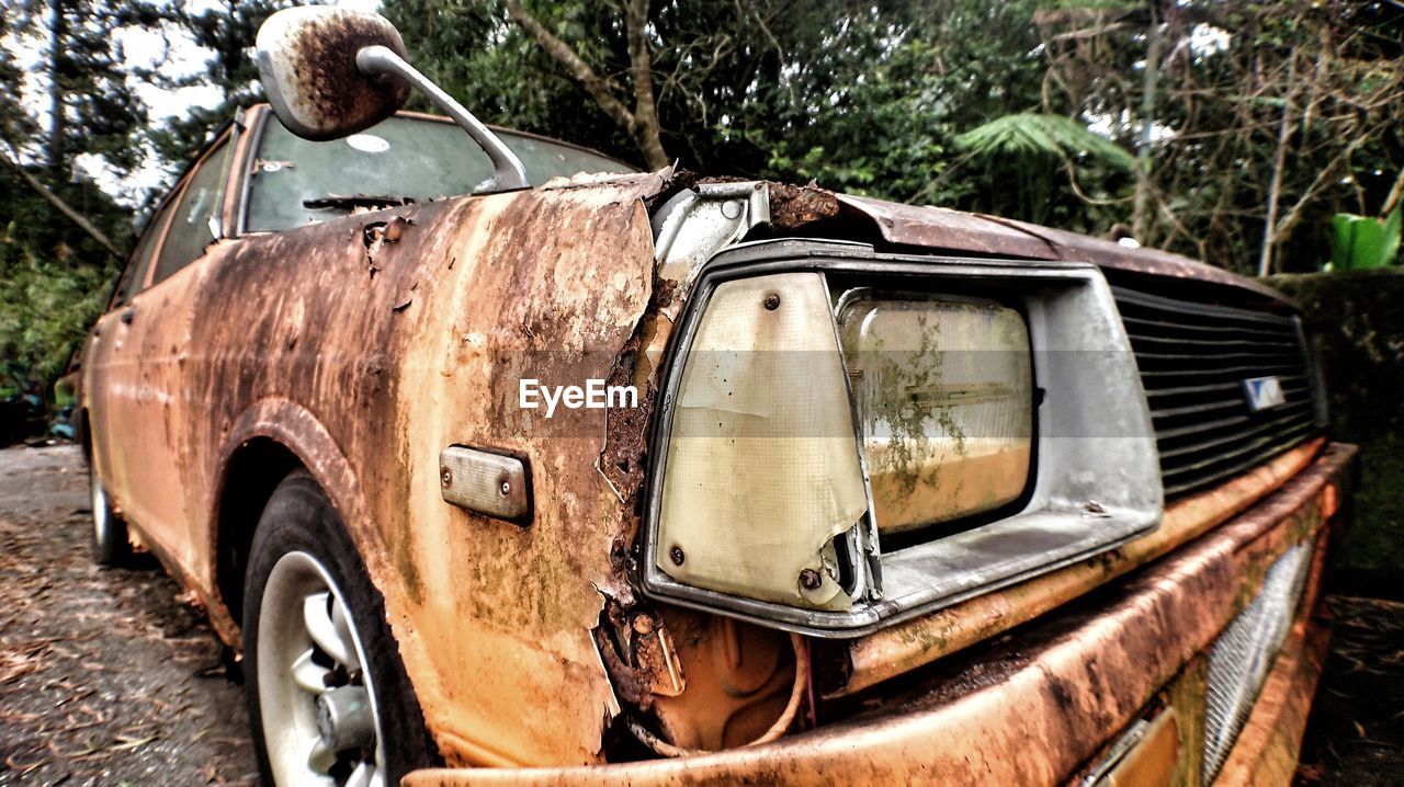 Old abandoned car outdoors