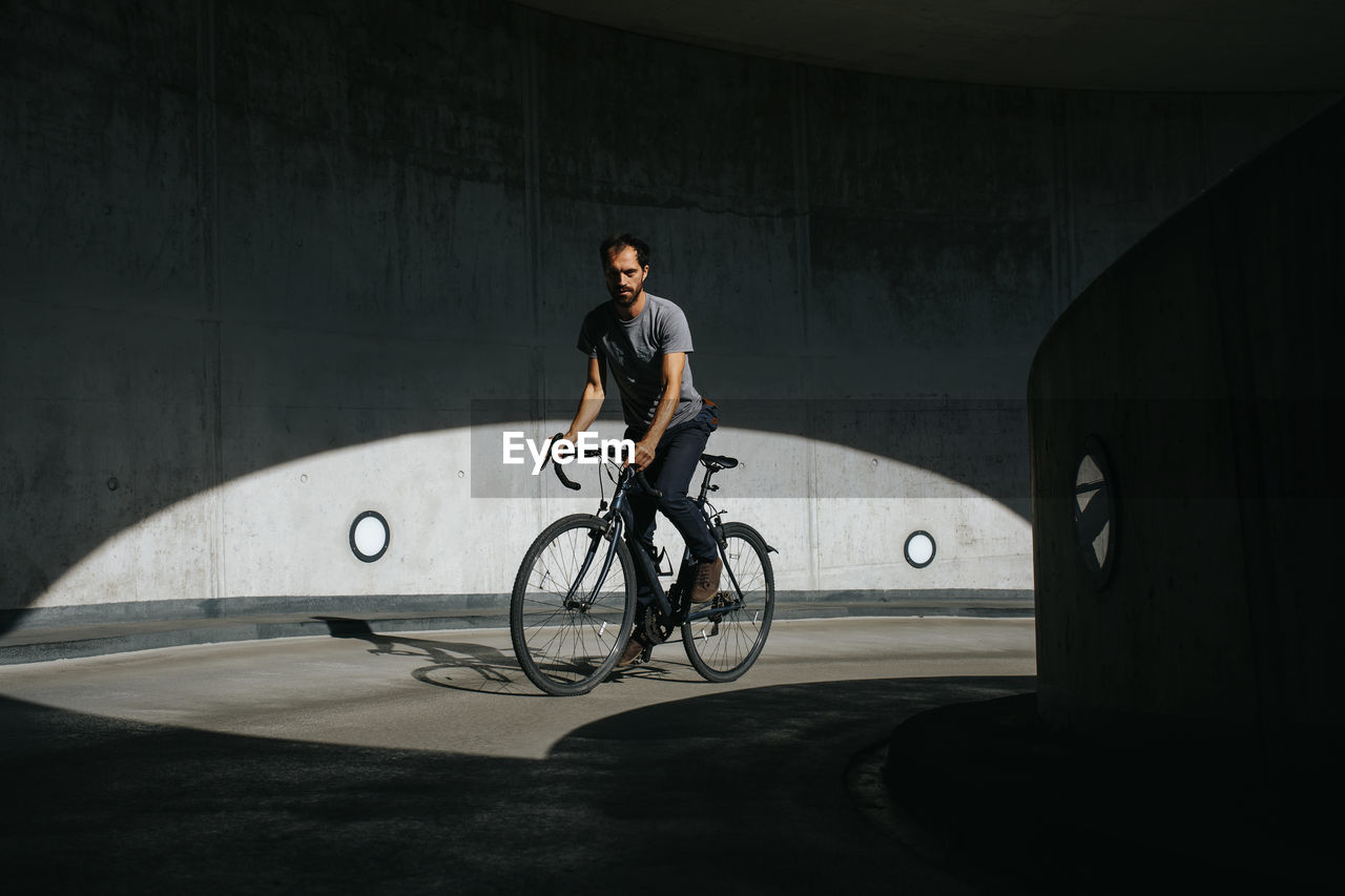 Man riding bicycle on bridge