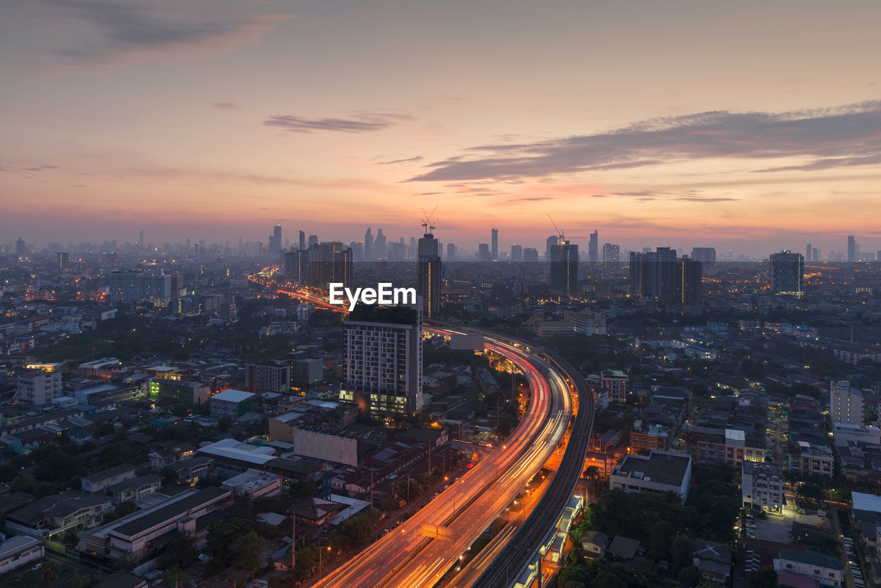 High angle view of illuminated cityscape against sky during sunset