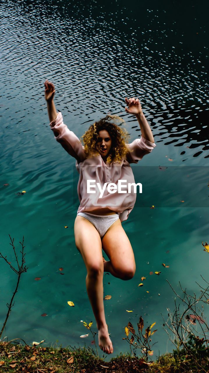 Young woman falling in lake