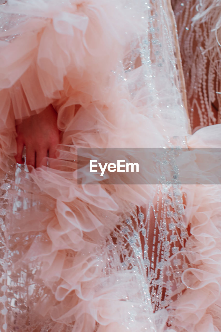 Fashion details of fluffy pastel pink haute couture boudoir dress. vertical fashion shot