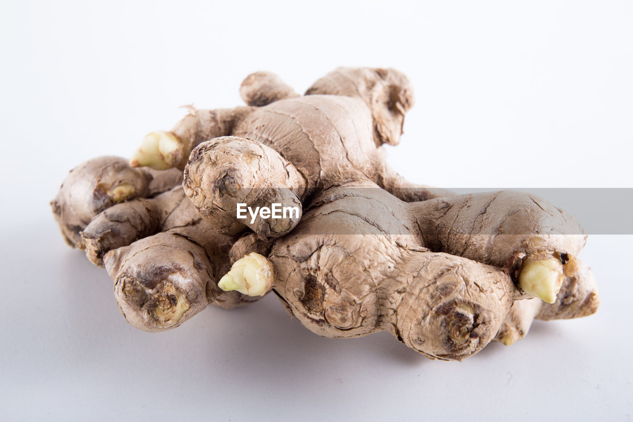 Close-up of ginger against white background