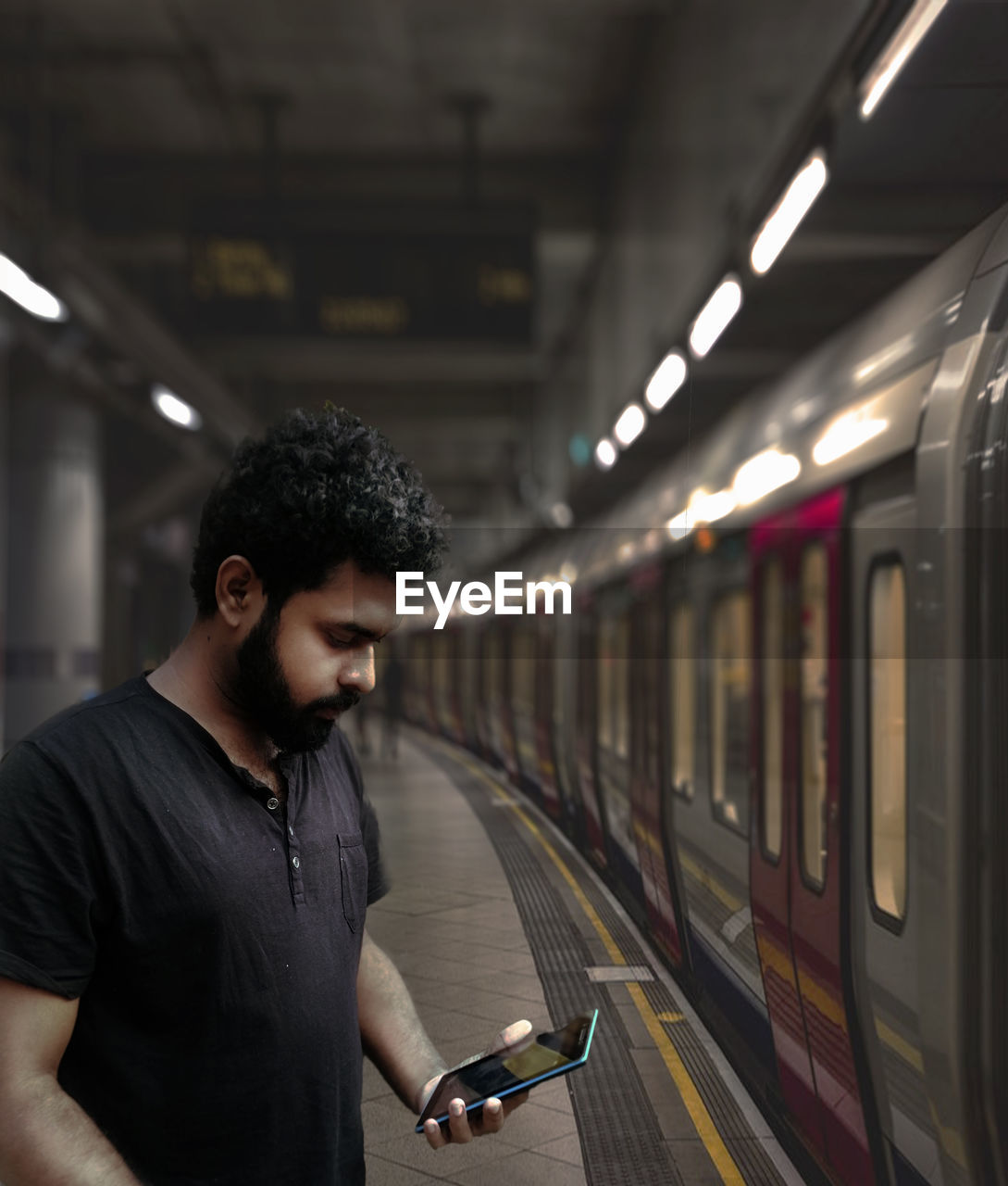  a cool guy standing  at metro station