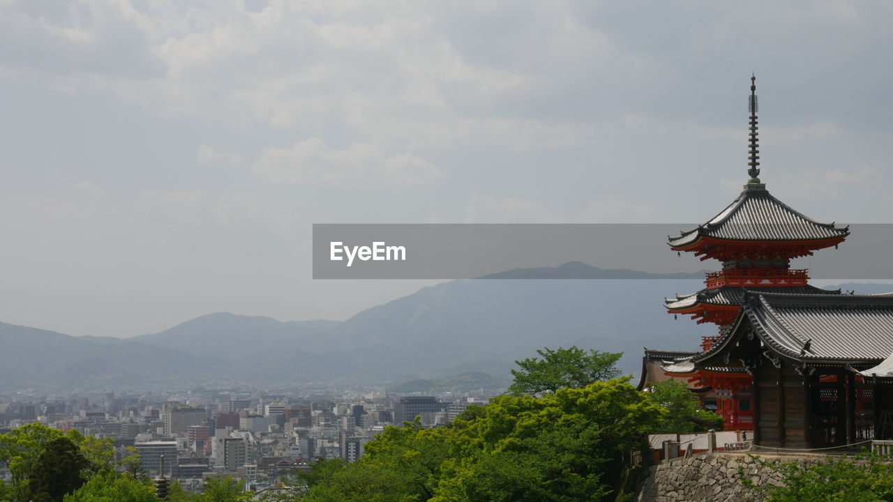 Kiyomizu dera temple by cityscape against mountains