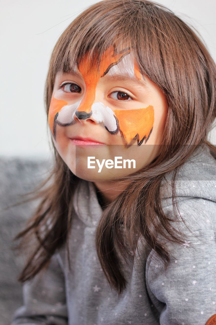 Close-up of little girl with fox face paint 