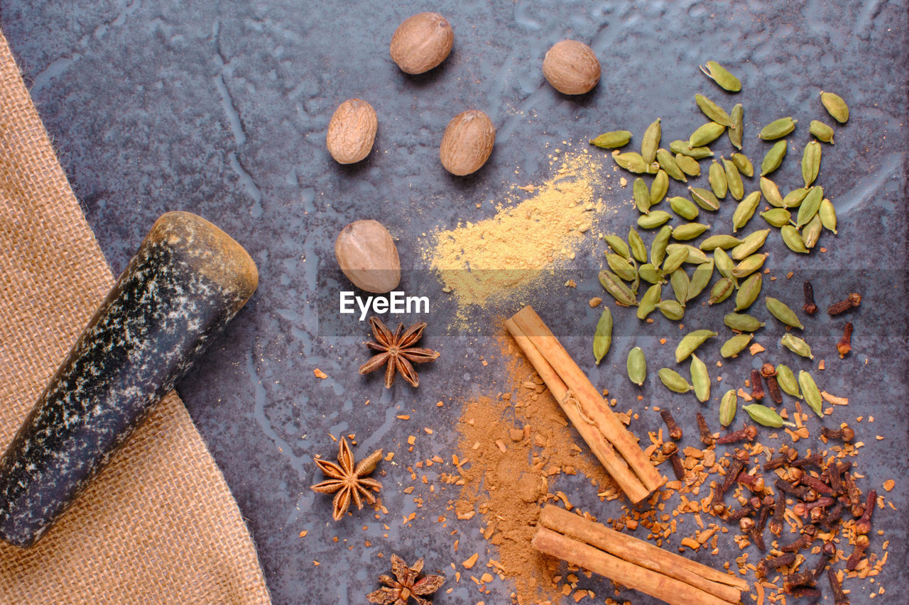 food and drink, spice, food, cinnamon, ingredient, star anise, high angle view, clove, leaf, cardamom, no people, wellbeing, still life, wood, healthy eating, freshness, indoors, herb, variation, spice mix, anise, dried food, nut, table, studio shot, nut - food, scented, plant, seed, seasoning, large group of objects, star shape, nature, produce, almond, directly above