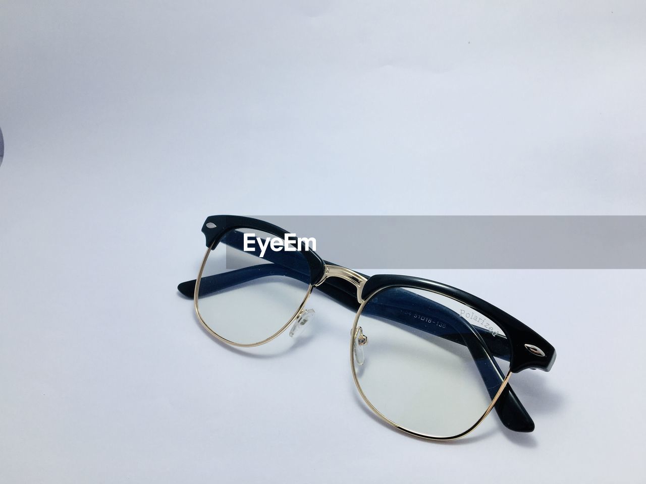 CLOSE-UP OF EYEGLASSES ON TABLE