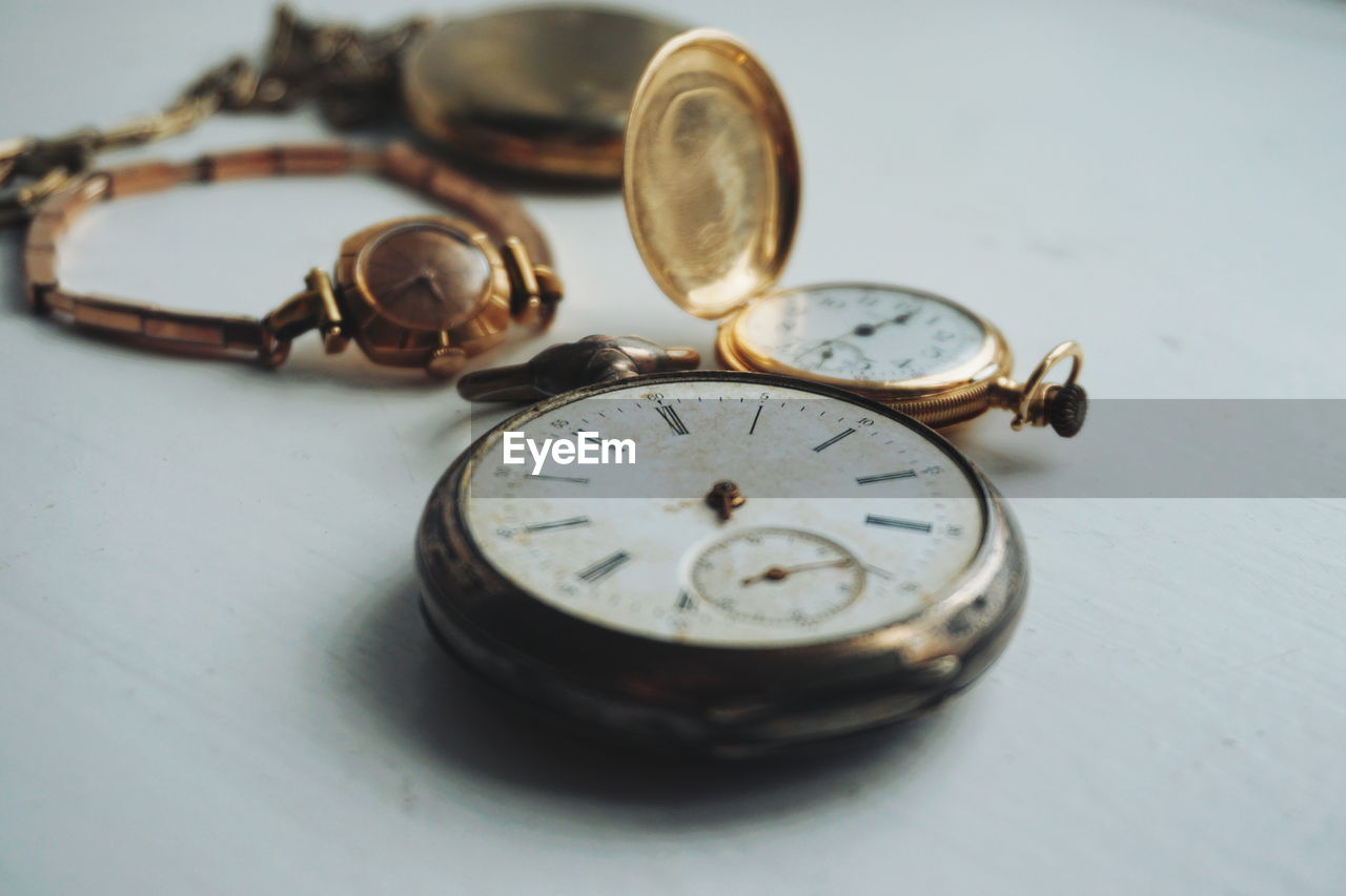 Close-up of antique watches on white table