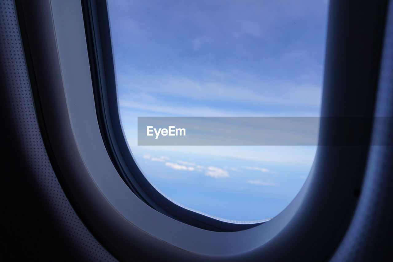 CLOSE-UP OF AIRPLANE WING OVER CLOUDS