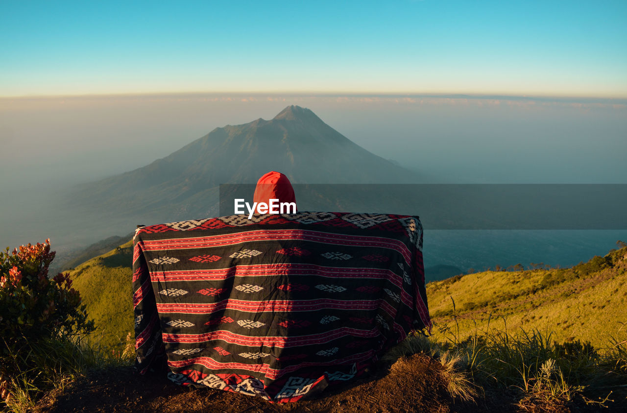 Enjoy the beauty at the top of mount merbabu with a view of mount merapi volcano