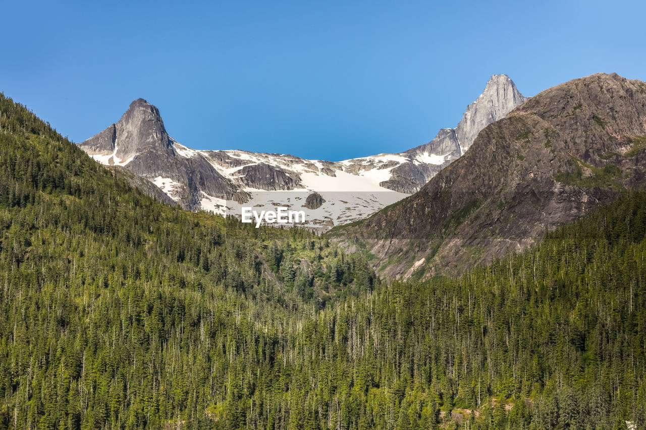 Scenic view of mountains against clear blue sky