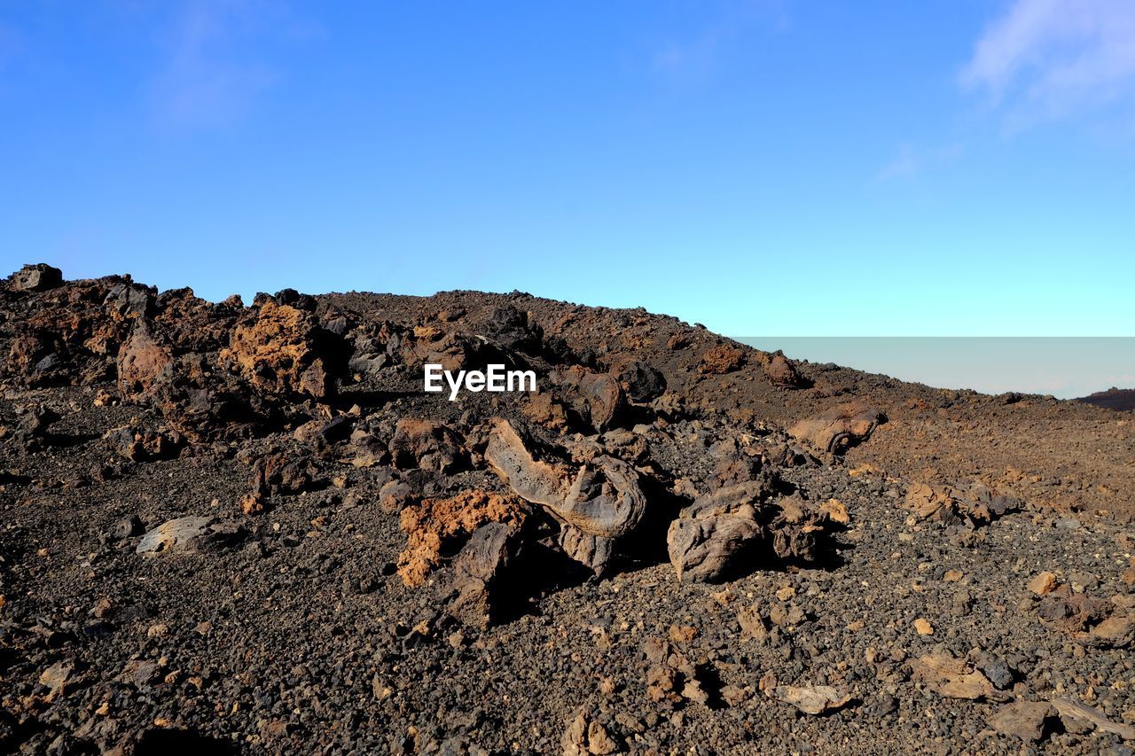 SCENIC VIEW OF ROCKS AGAINST CLEAR SKY