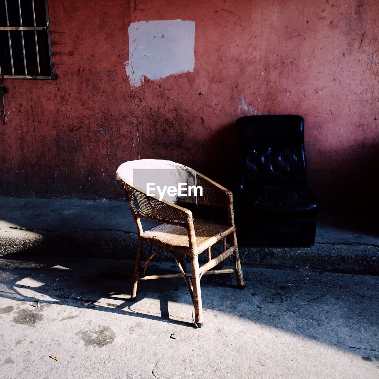 Empty chairs by abandoned building