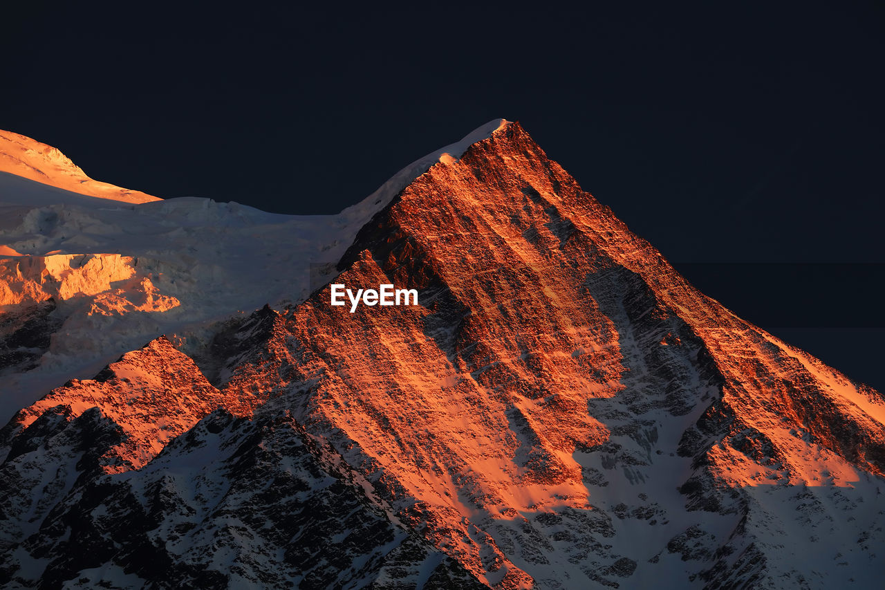 Panoramic view of mountains against sky at night