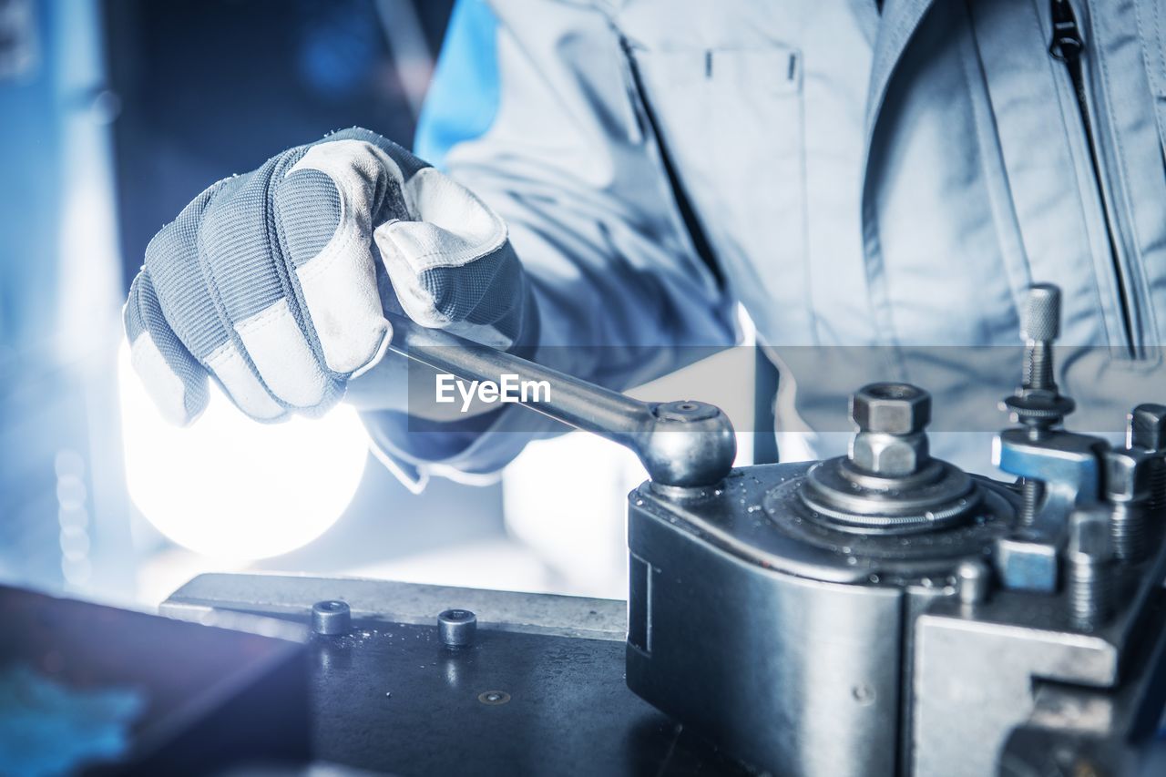 Midsection of manual worker working in factory