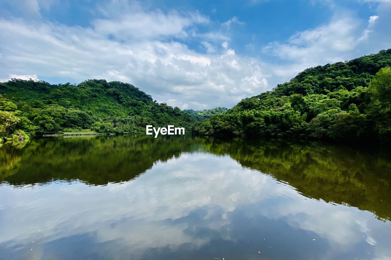 reflection, nature, water, sky, cloud, environment, landscape, river, tree, scenics - nature, beauty in nature, body of water, plant, tranquility, forest, land, no people, reservoir, tranquil scene, travel destinations, green, mountain, travel, outdoors, non-urban scene, tourism, social issues, blue, natural environment, summer, idyllic, reflection lake, wilderness, trip, vacation, holiday, day, environmental conservation
