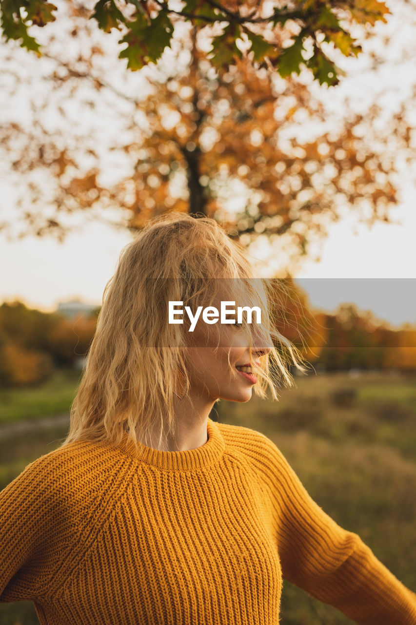 Portrait of young woman looking away outdoors