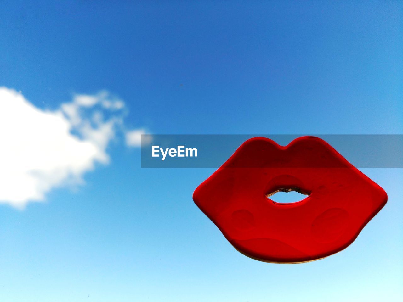 CLOSE-UP OF RED HEART SHAPE AGAINST SKY
