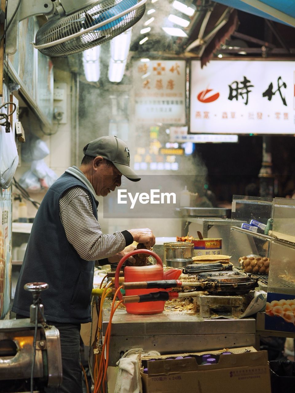 MAN WORKING AT MARKET STALL