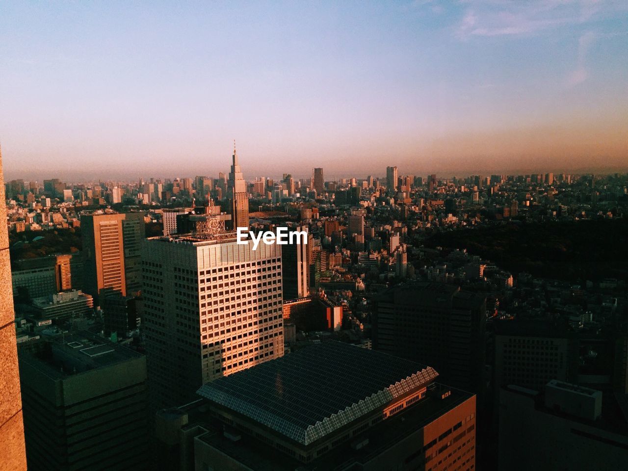 Aerial view of cityscape against sky during sunset