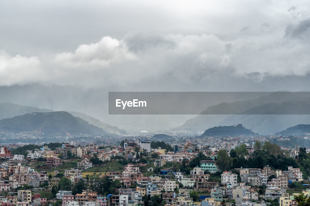 A view of the population density in city of kathmandu under a stormy sky.
