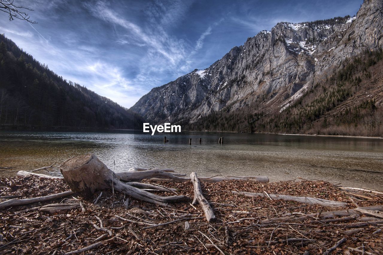 Scenic view of lake by mountains against sky