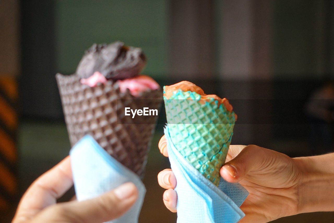 Cropped image of people holding ice cream