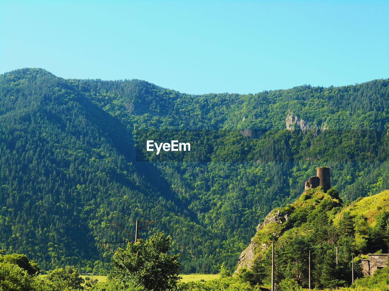 Scenic view of tree mountains against clear sky