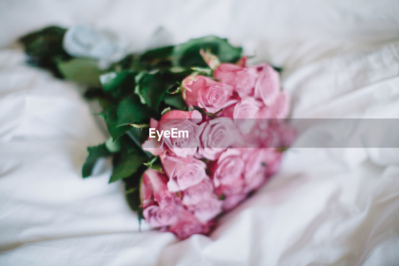 High angle view of rose bouquet on bed