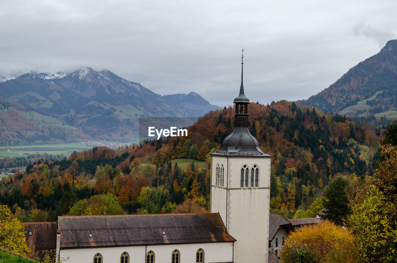 Church by building against sky