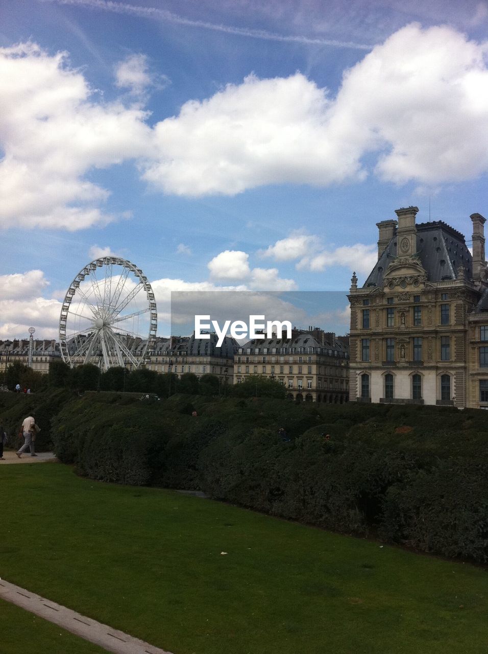 VIEW OF PARK AGAINST CLOUDY SKY