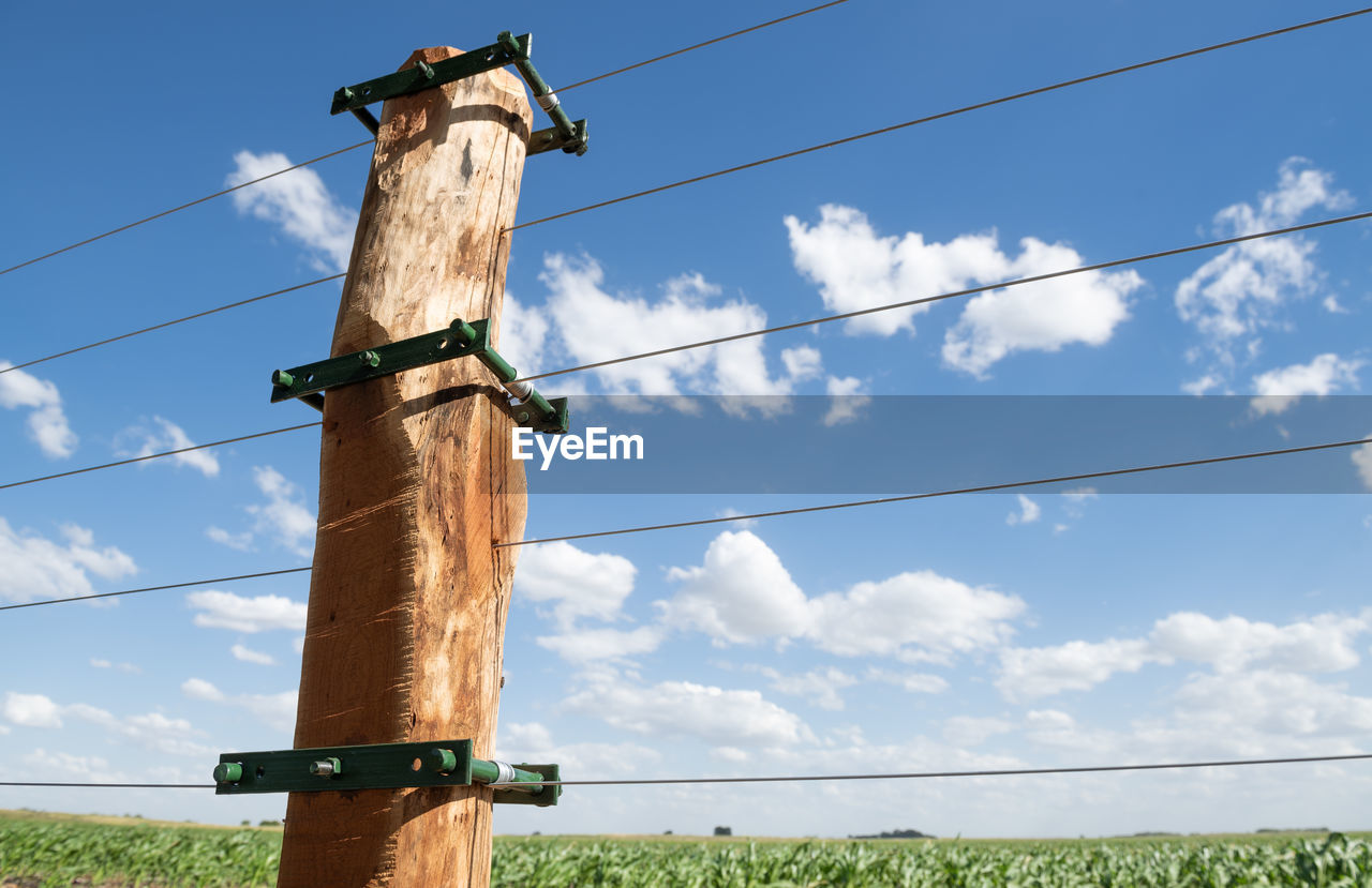 LOW ANGLE VIEW OF POLE AGAINST SKY