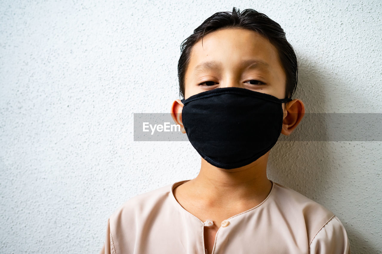 Asian young kids are wearing hygienic reusable face mask to prevent the virus. new normal.