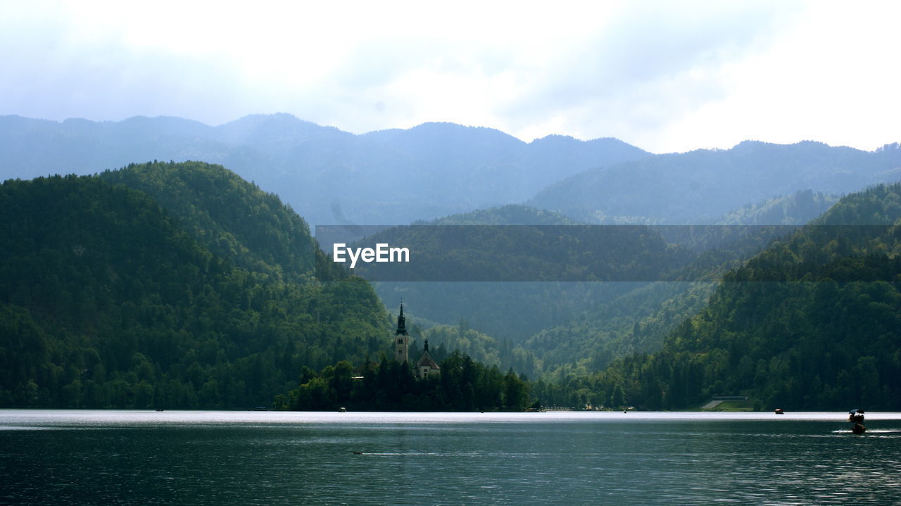 Scenic view of lake and mountains against sky