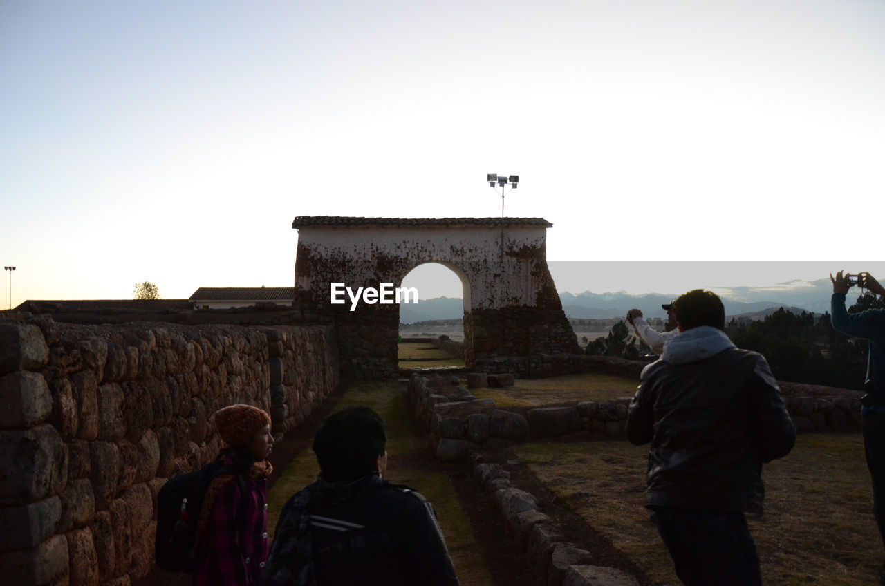 TOURISTS VISITING RUINS