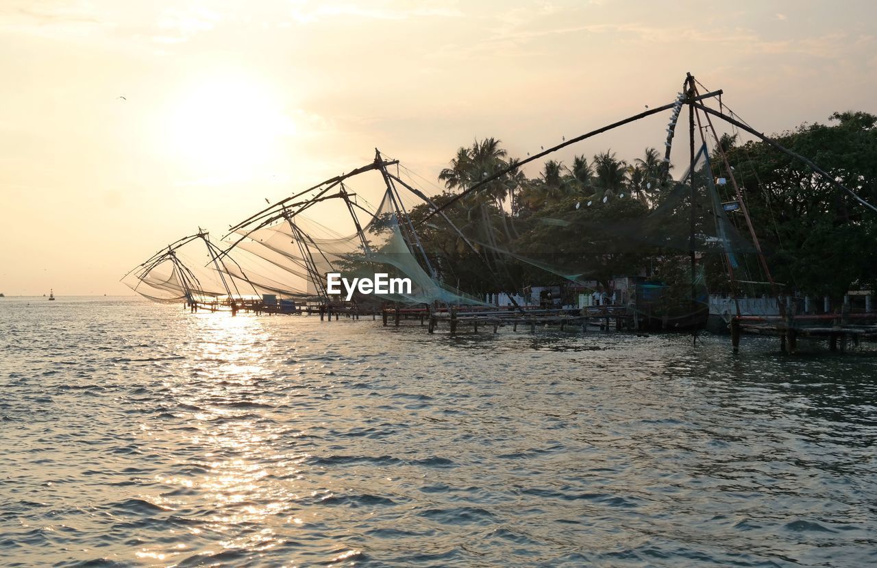 Scenic view of river against sky during sunset