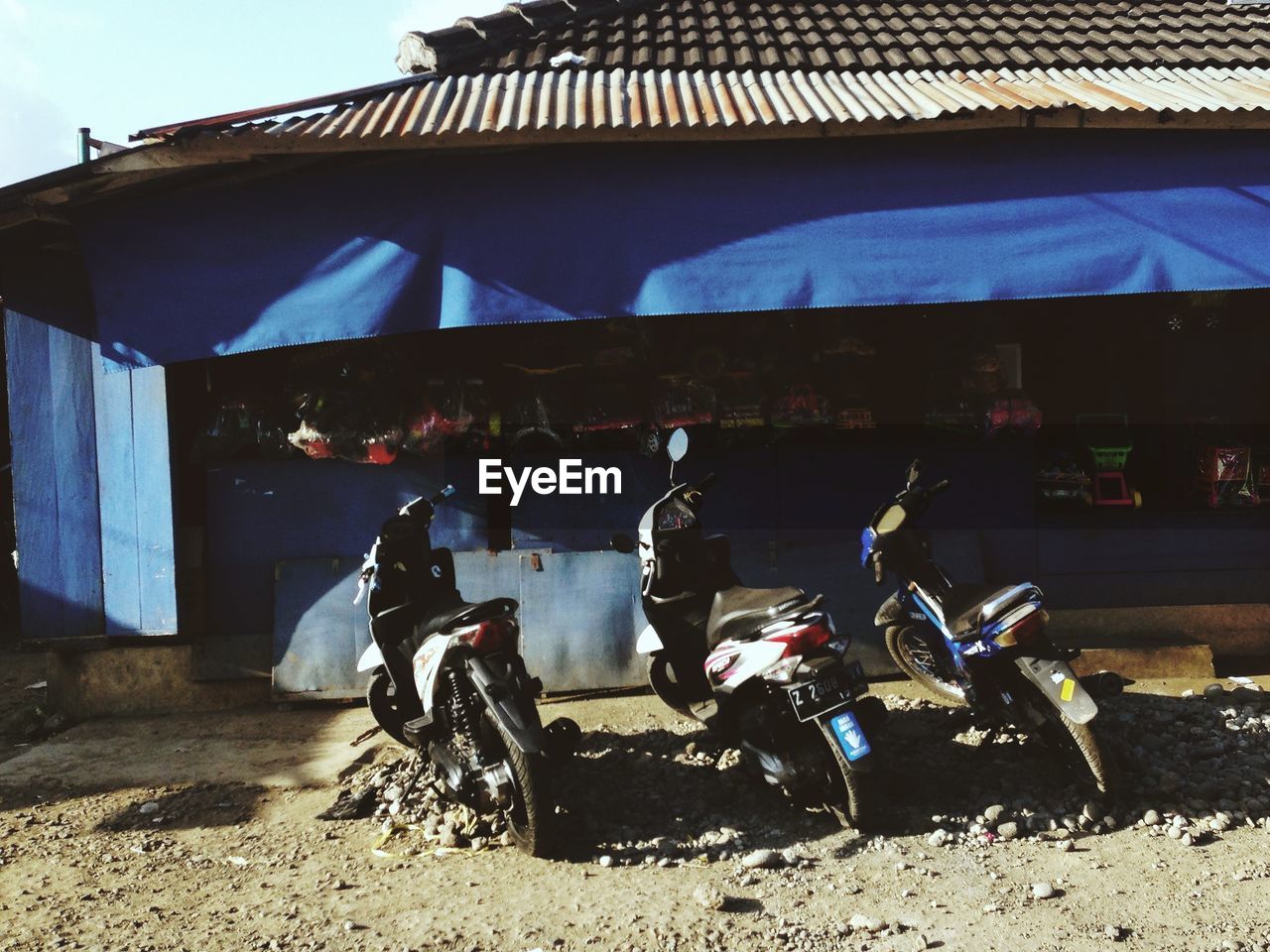 Motorbikes parked in front of a store