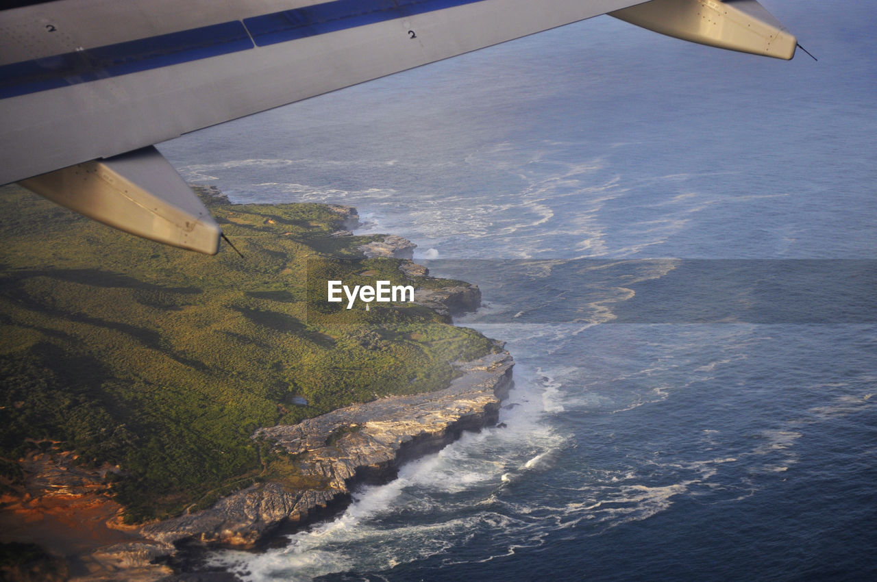 Cropped image of airplane over sea