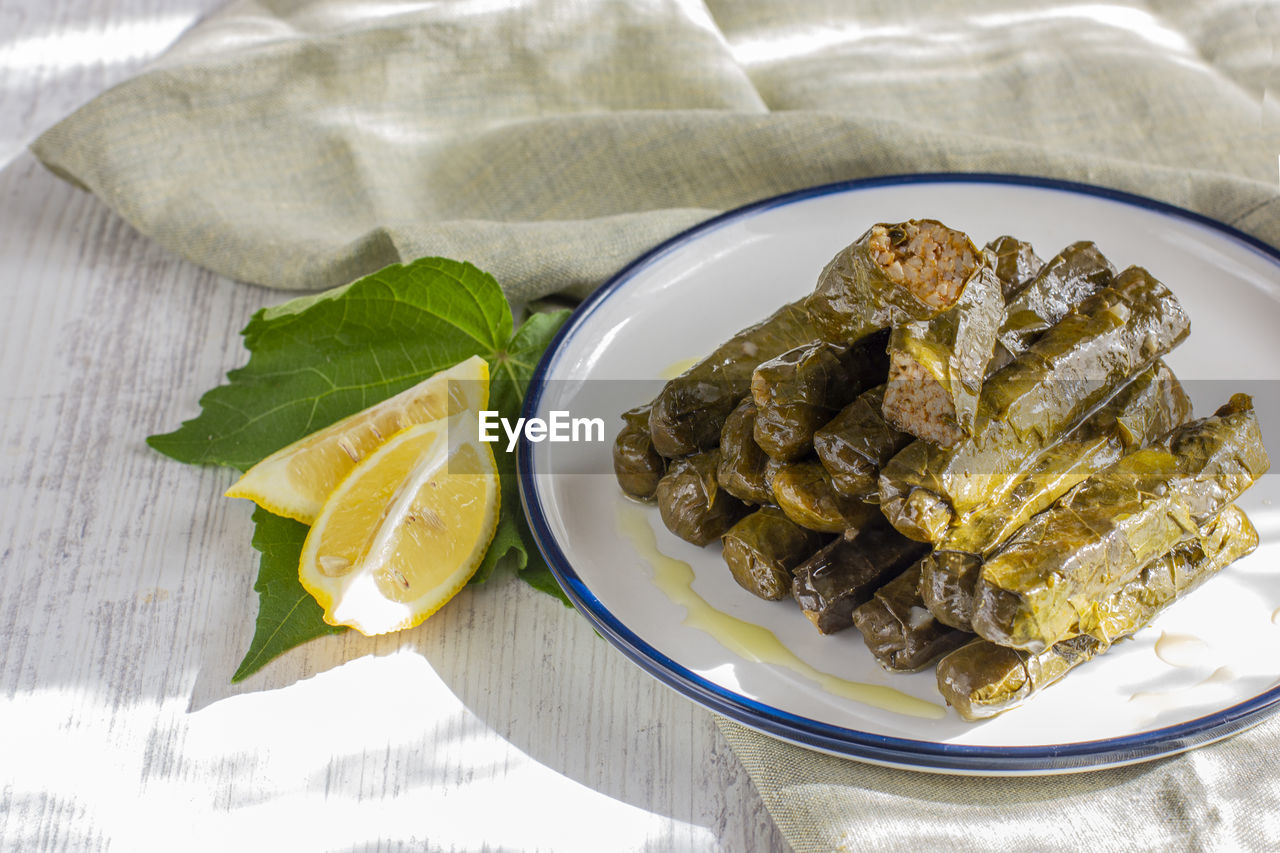 Traditional turkish meal - yaprak dolma. stuffed grape leaves with olive oil and fresh lemon